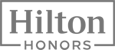 The image shows the Hilton Honors logo, featuring the text "Hilton Honors" in a stylized font within a rectangular frame.