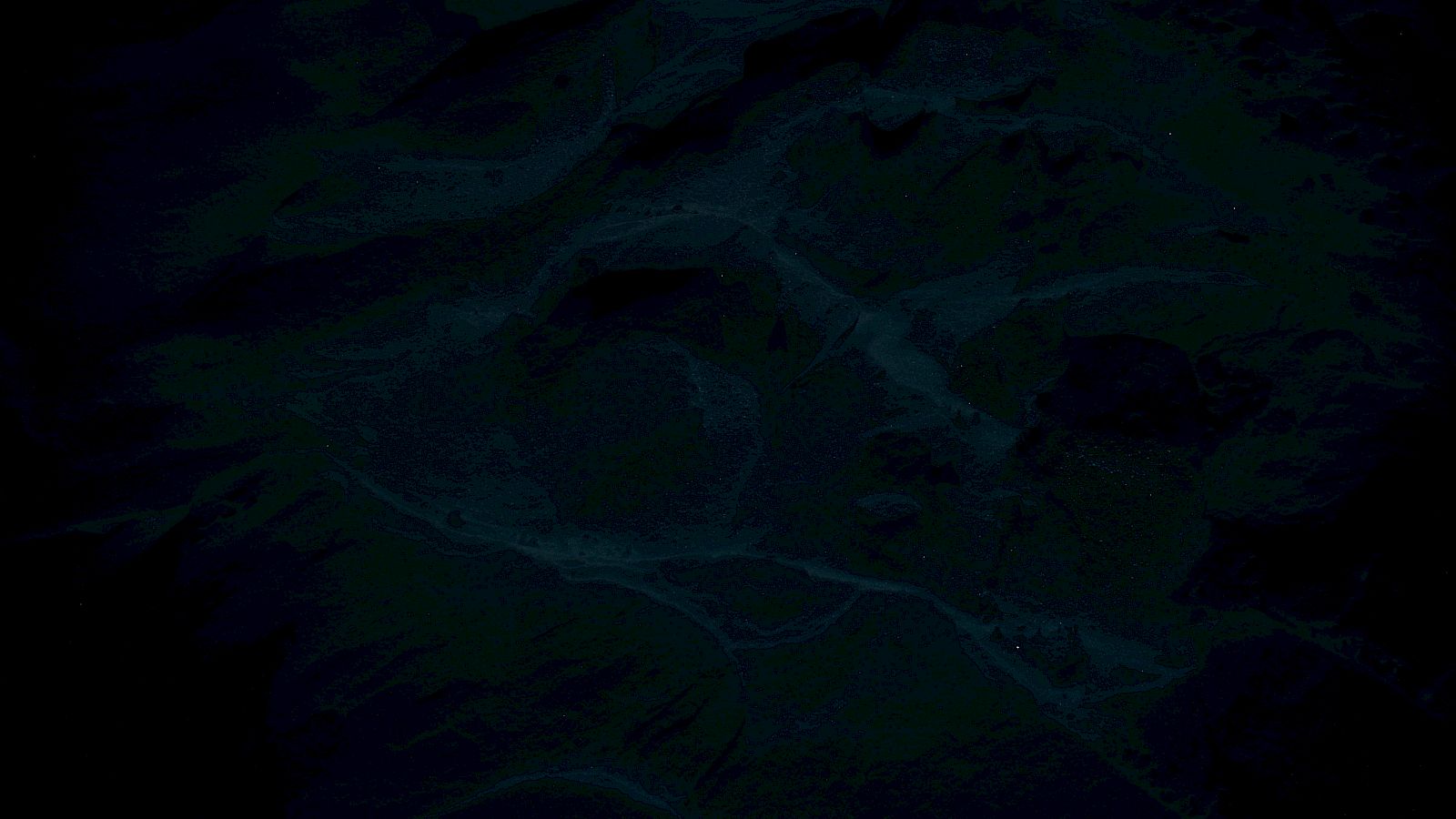 The image appears to show a dark, abstract pattern with swirling shapes and varying shades of green and blue.